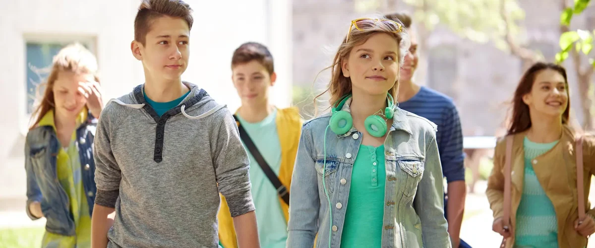 education-high-school-communication-people-concept-group-happy-teenage-students-walking-outdoors_ glotty teenagers